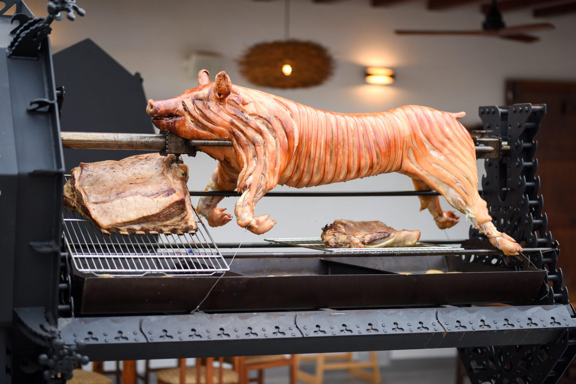Whole pig roasting on The Beast